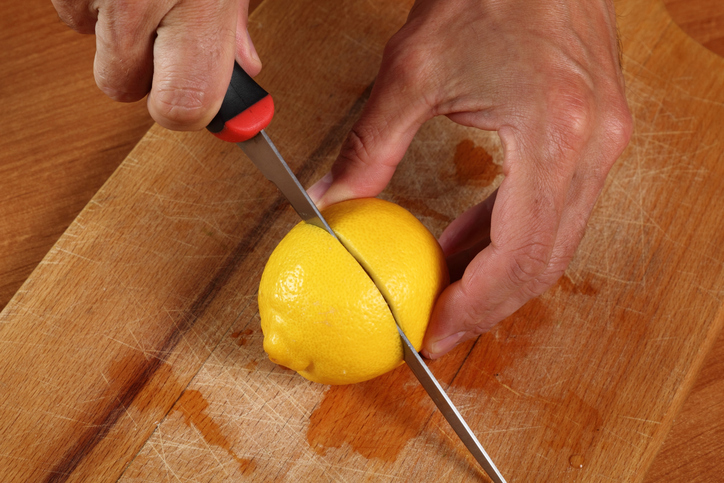 Clean stainless steel appliances with a halved lemon